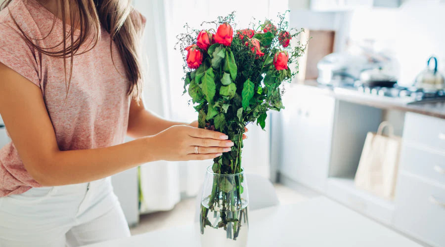Fresh bouquet being trimmed and placed in a clean vase of water