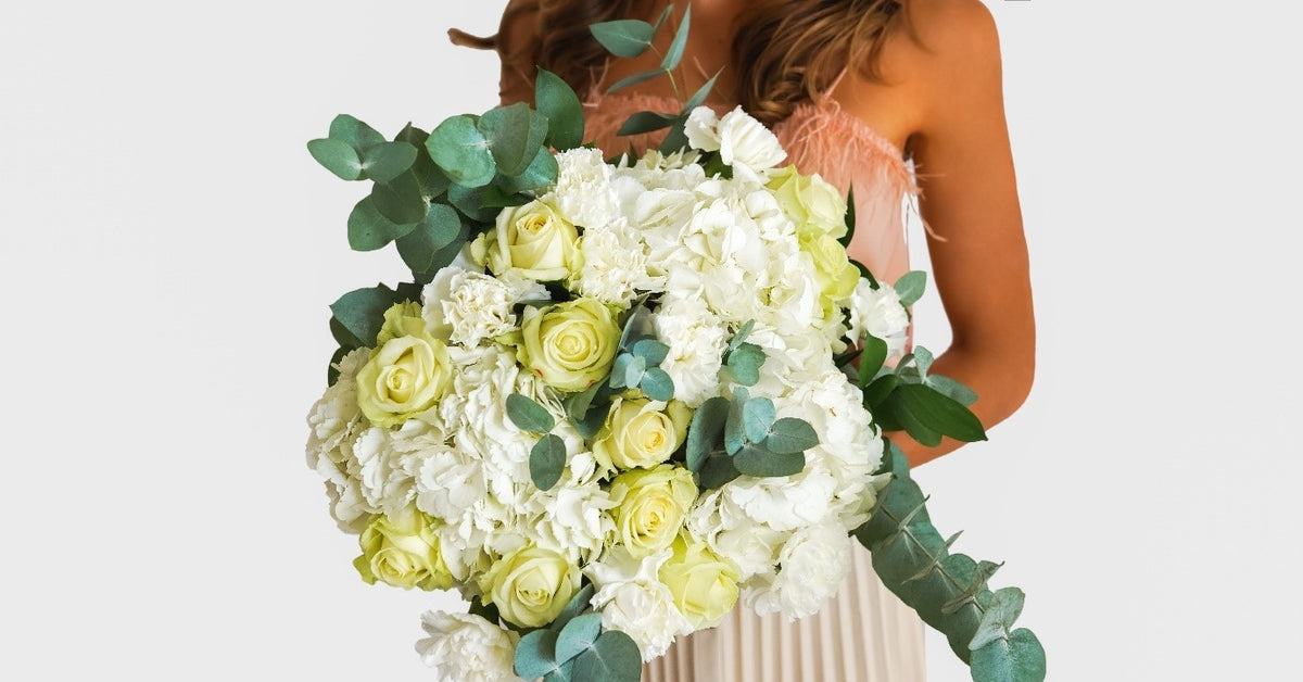 White Feeling bouquet of white hydrangea, ivory roses and eucalyptus by Coral Flowers London