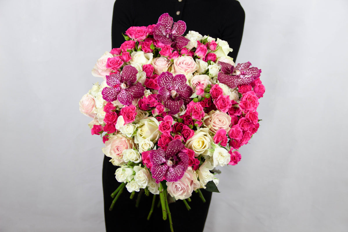 Ivy bouquet of white roses, pink spray roses and pink Vanda orchids by Coral Flowers London