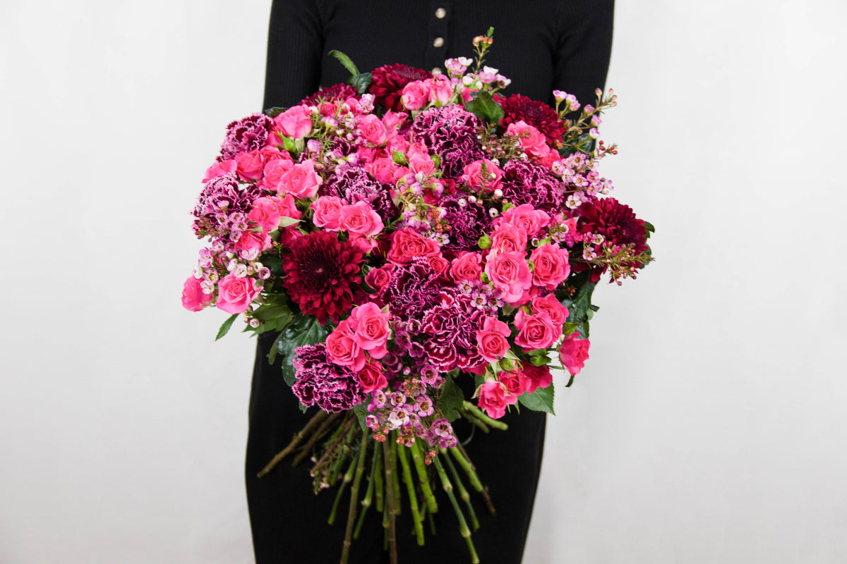 Daisy bouquet of red chrysanthemums and pink spray roses by Coral Flowers London