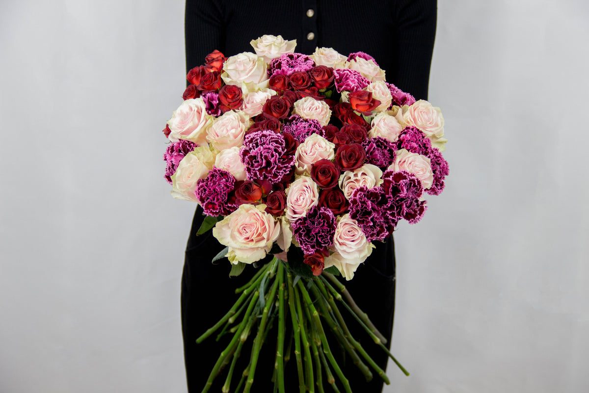 Sherlota bouquet of purple carnations, white roses and red spray roses by Coral Flowers London